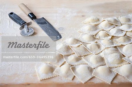 Fresh, homemade ravioli on a floured work surface Fresh, homemade ravioli on a floured work surface