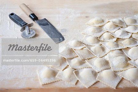 Fresh, homemade ravioli on a floured work surface