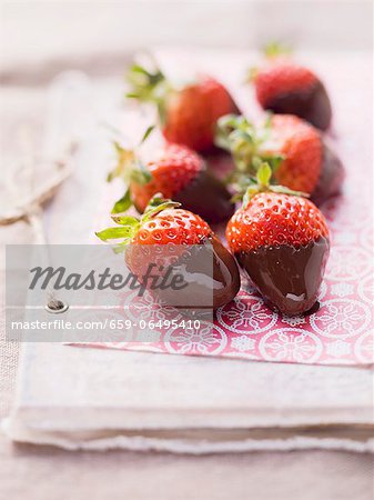 Chocolate strawberries on pink paper