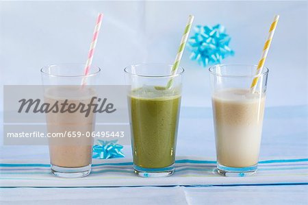 A strawberry smoothie, a matcha smoothie and a lucuma smoothie