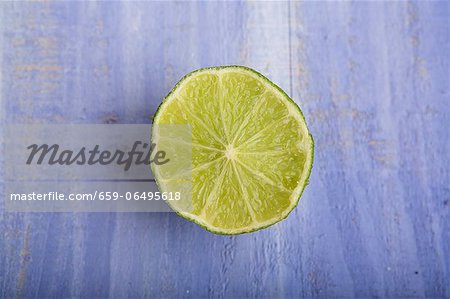 Half a lime on a blue surface