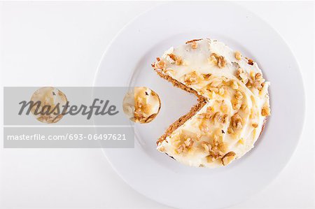 Walnut cake in plate over white background