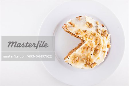 Walnut cake in plate over white background