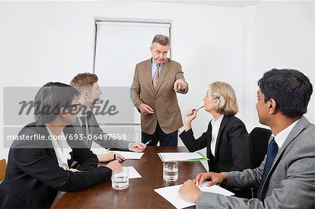 Multiethnic businesspeople at meeting in conference room