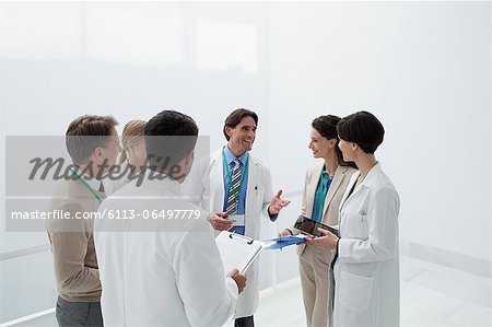 Smiling doctors discussing medical charts