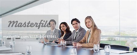 Portrait of confident business people at table in conference room