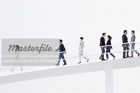 Business people walking down elevated walkway