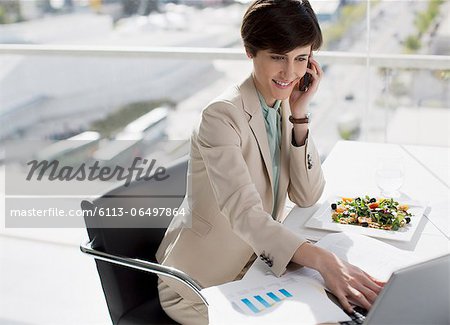 Businesswoman multitasking at desk