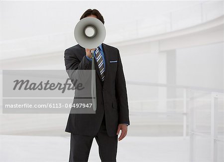 Portrait of businessman with bullhorn