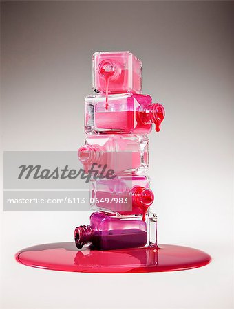 Multicolor fingernail polish dripping from stacked bottles Multicolor fingernail polish dripping from stacked bottles