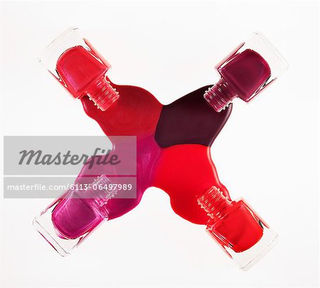 Multicolor fingernail polish spilling from bottles Multicolor fingernail polish spilling from bottles
