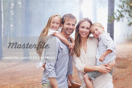 Portrait of smiling family in woods