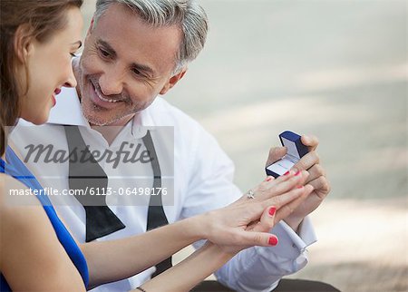 Man with engagement ring proposing to woman Man with engagement ring proposing to woman
