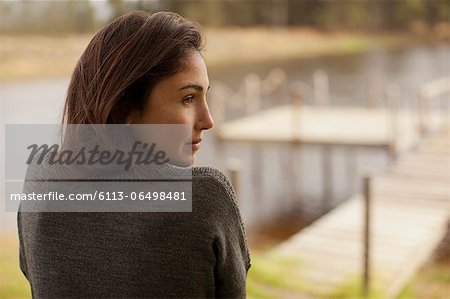 Pensive woman at lakeside