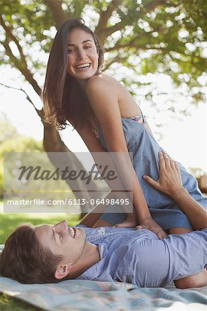 Portrait of smiling couple on blanket in grass