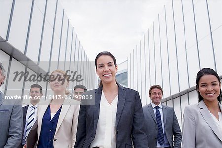 Portrait of smiling business people walking