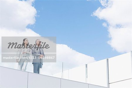 Businessman and businesswoman on balcony