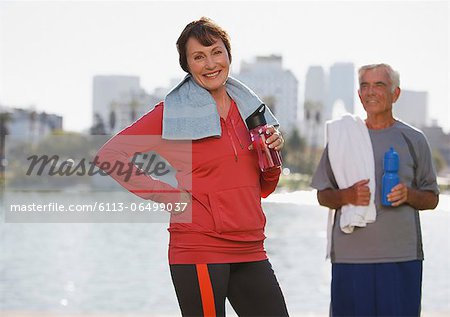 Older couple drinking water during workout