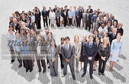 Portrait of smiling business people forming circle Portrait of smiling business people forming circle