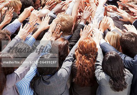 Crowd of business people reaching