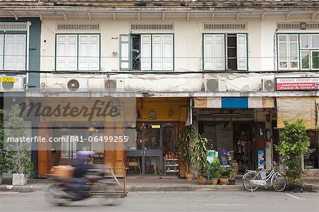 A motorbike rides past a shop front in Rattanakosin, Bangkok, Thailand, Southeast Asia, Asia