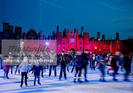 A skating rink in front of Hampton Court Palace lit with red lights, Greater London, England, United Kingdom, Europe