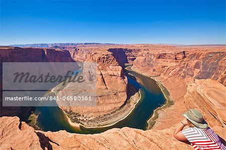 Tourist overlooking Horseshoe Bend on the Colorado River, Page, Arizona, United States of America, North America