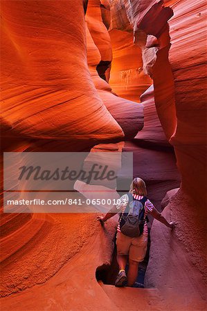 Female tourist hiker and Sandstone Rock formations, Lower Antelope Canyon, Page, Arizona, United States of America, North America