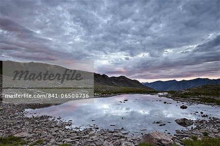 Clouds reflected in a tarn at Stony Pass, San Juan National Forest, Colorado, United States of America, North America