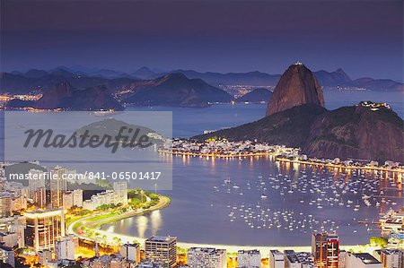 View of Sugar Loaf Mountain (Pao de Acucar) and Botafogo Bay at dusk, Rio de Janeiro, Brazil, South America