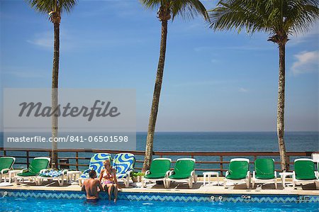 Couple relaxing by pool at Sheraton Hotel, Rio de Janeiro, Brazil, South America
