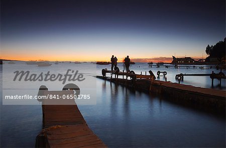 People standing on pier at sunset, Copacabana, Lake Titicaca, Bolivia, South America