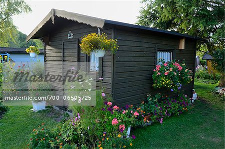 Small Wooden Garden House Surrounded by Blooming Flowers, Bavaria, Germany, Europe Small Wooden Garden House Surrounded by Blooming Flowers, Bavaria, Germany, Europe
