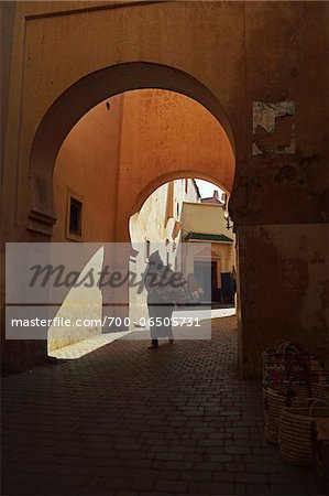 Person Walking Through Archway in Street Scene in the Old Town, Medina, Marrakesh, Morocco, Africa