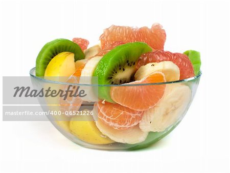 Fruit salad with citrus in a glass bowl on a white background