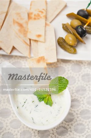 fresh Greek Tzatziki yogurt dip and pita bread and pickels