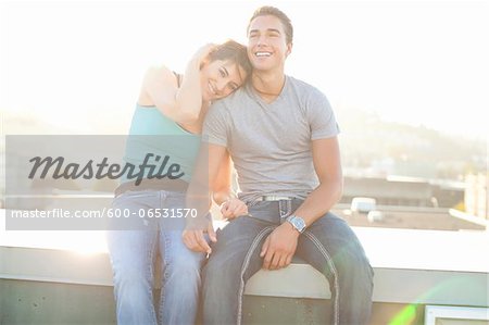 Portrait of Couple Sitting on Rooftop Outdoors, Portland, Oregon, USA