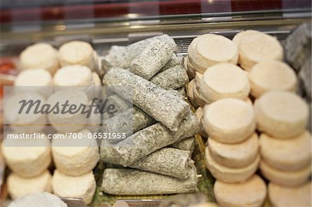 Fresh wedges and rounds of French goat cheese in artisan cheese shop, La Fromagerie, Paris, France