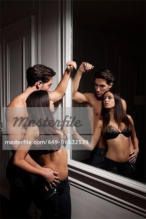 Couple admiring themselves in mirror