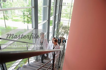 Doctors climbing staircase in office