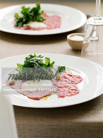 Plate of carpaccio with salad