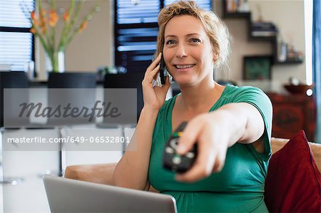 Woman on phone watching television