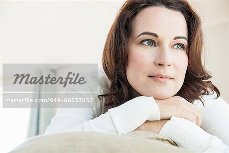 Woman relaxing on sofa in living room