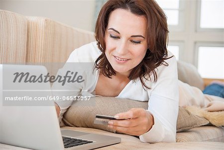Woman shopping online on sofa