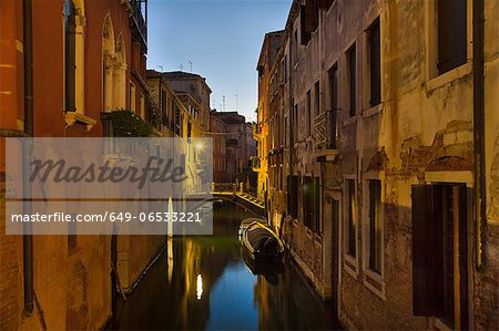 Rowboat and buildings on urban canal