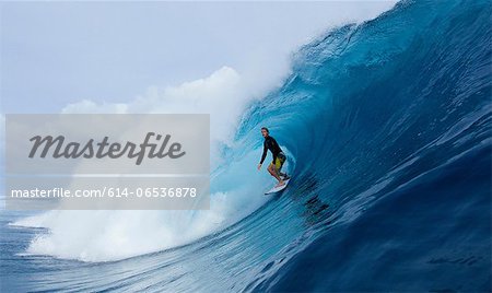 Man surfing in curl of wave