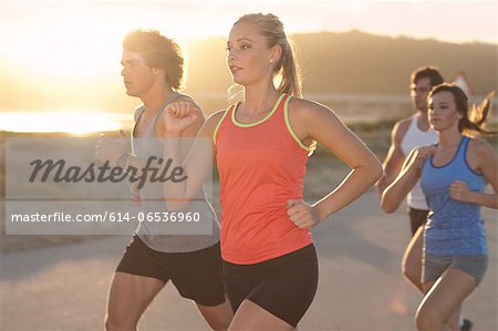 Friends running on beach