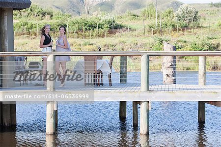 Women standing on wooden deck outdoors