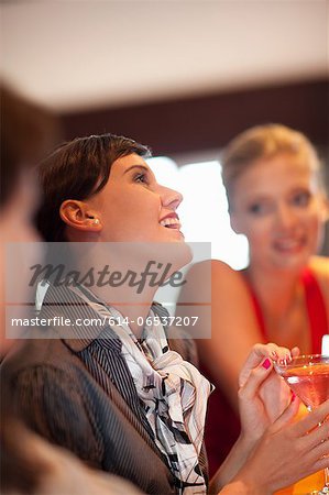 Women having drinks together at bar