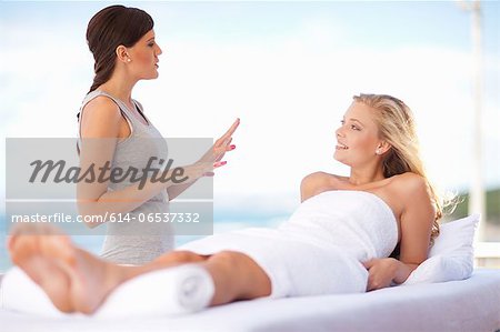 Masseuse talking to client outdoors